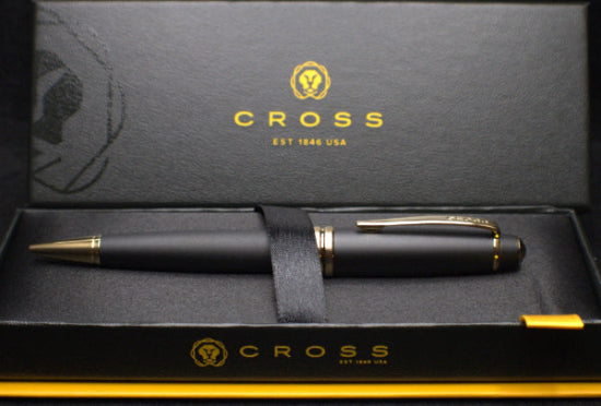 Black pen with gold accents in a Cross branded box
