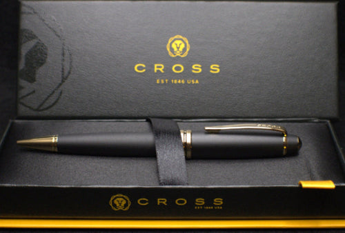Black pen with gold accents in a Cross branded box