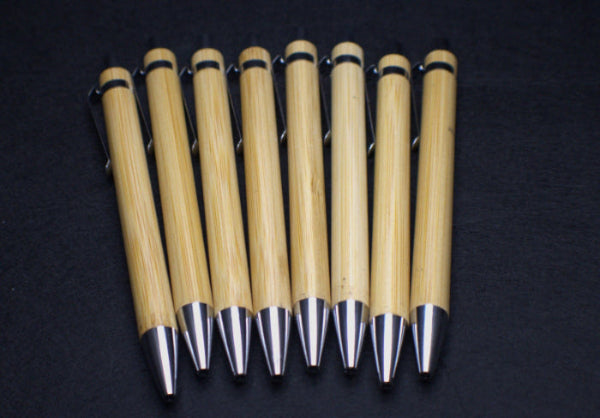 Set of wooden pens with metallic tips on a dark background