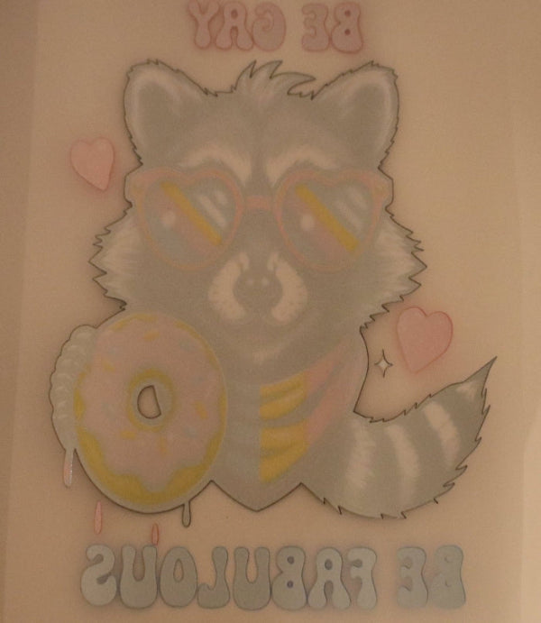 Cartoon raccoon wearing sunglasses with a donut, on a light pink background.