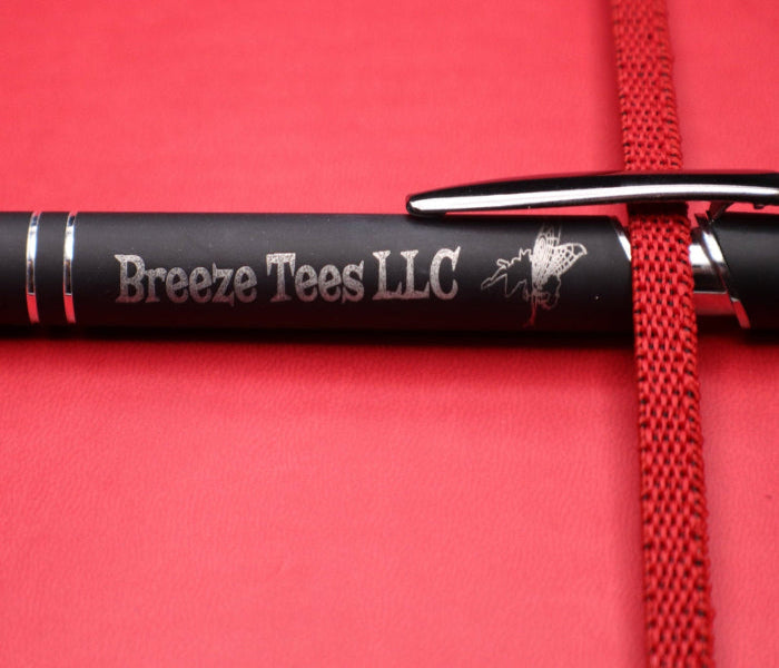 Black pen with 'Breeze Tees LLC' branding on a red background