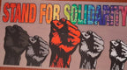 Colorful DTF design with raised fists and 'Stand for Solidarity' text.