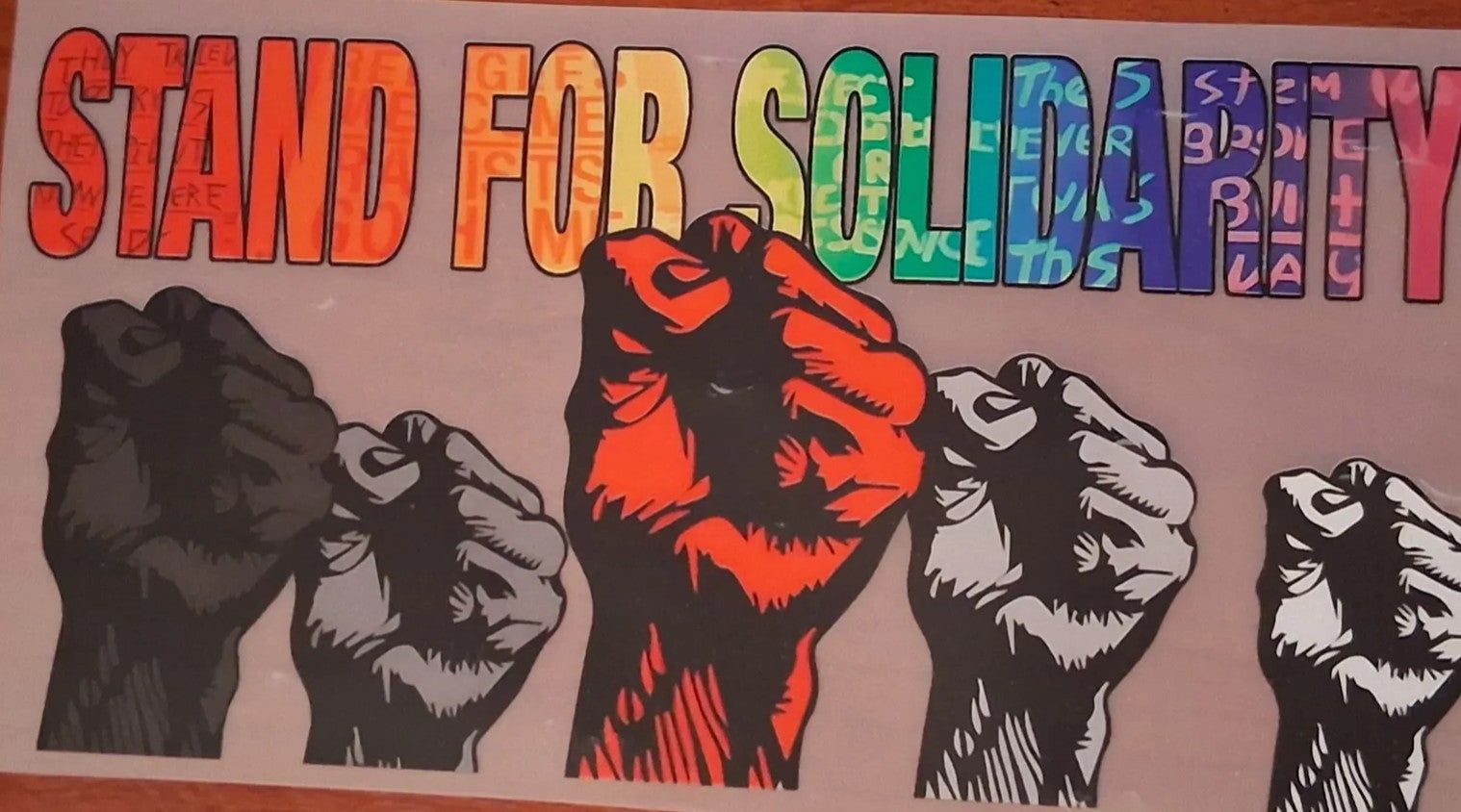Colorful DTF design with raised fists and 'Stand for Solidarity' text.