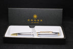 Cross pen set with white body and gold accents in a black box on a black background