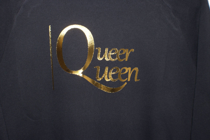 Black sweatshirt with gold 'Queer Queen' text on a plain background